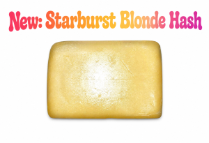Golden block of Starburst Blonde Hash premium cannabis concentrate with a smooth blonde texture and rich resin appearance on a white background.