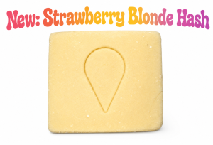 Golden block of Strawberry Blonde Hash premium cannabis concentrate with a smooth blonde texture and sweet strawberry-inspired terpene profile on a white background.