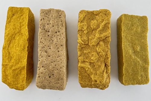 Assortment of seven golden blonde hash bricks available to buy as indica hash online Canada, showing soft, shiny texture.