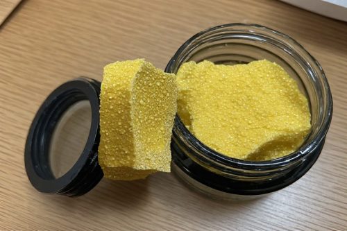 Golden hash brick stored in an airtight glass jar to keep hash fresh — a must for those who buy indica hash online Canada.