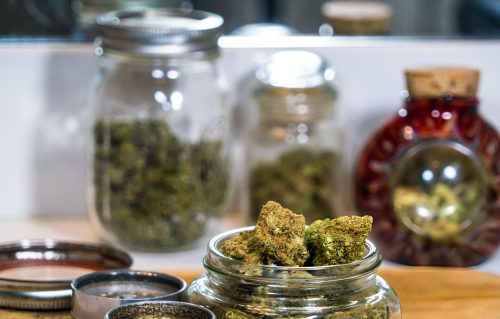An airtight mason jar in a freezer demonstrating how to properly store blonde cannabis edibles in Canada