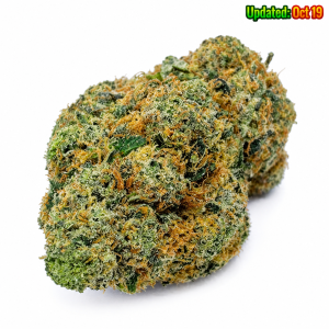 Donkey Butter indica cannabis flower featuring dense green buds, bright orange pistils, and frosty white trichomes.